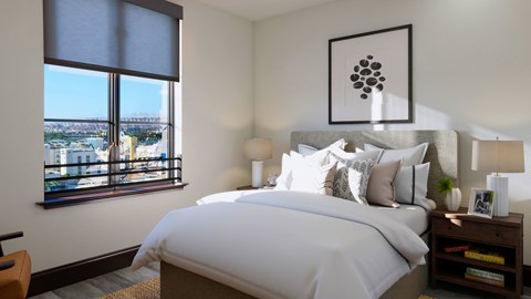 A bedroom with a large bed and a view of the city through the window.