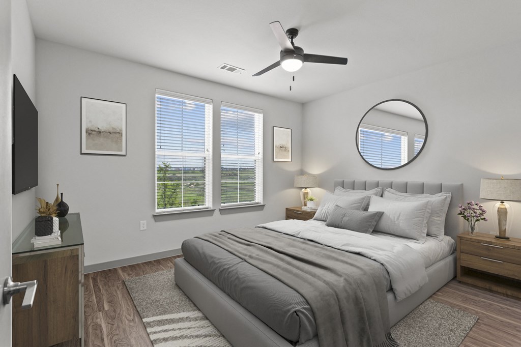 a bedroom with a large bed and a ceiling fan