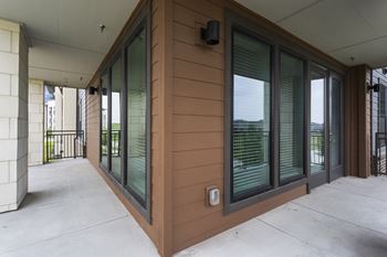 a view of the front porch of a building with windows