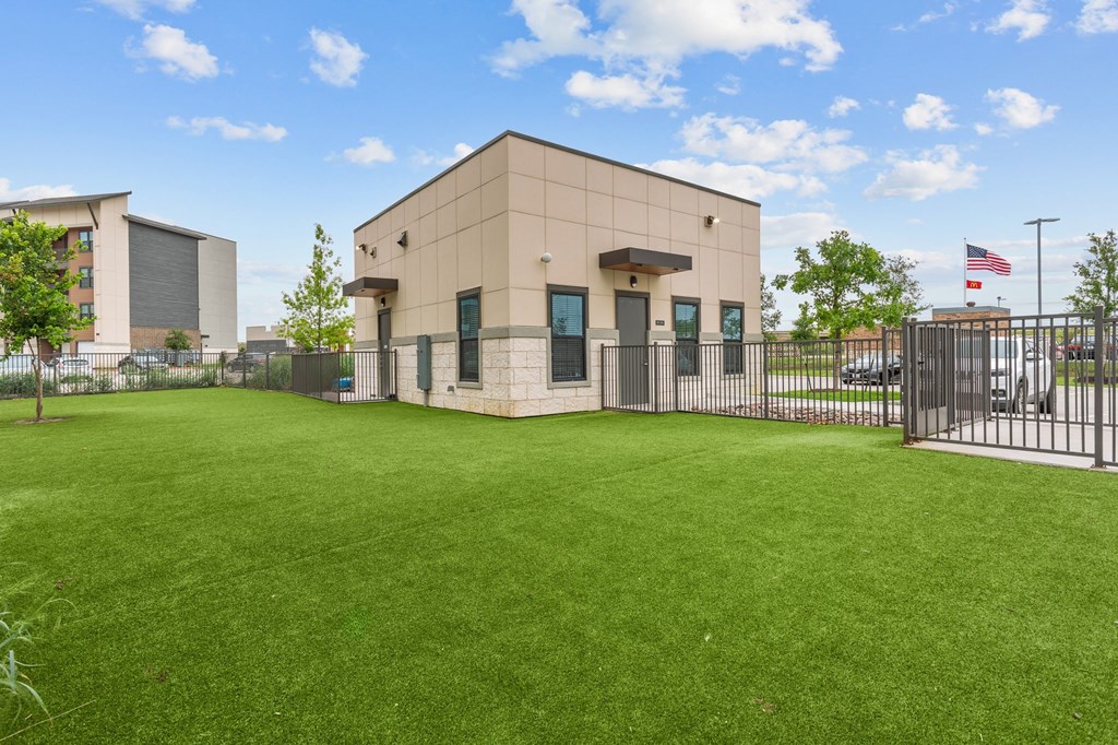 the preserve at ballantyne commons office building with a green lawn and a fence