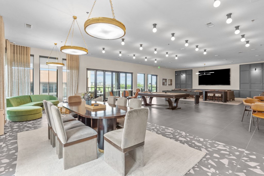 a living room with a table and chairs and a television