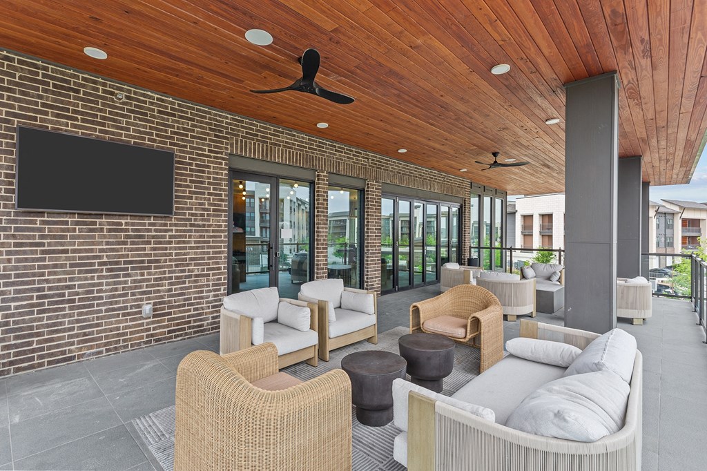 a lounge area with couches and chairs and a television