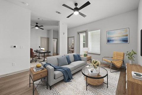 A living room with a grey couch and a coffee table.