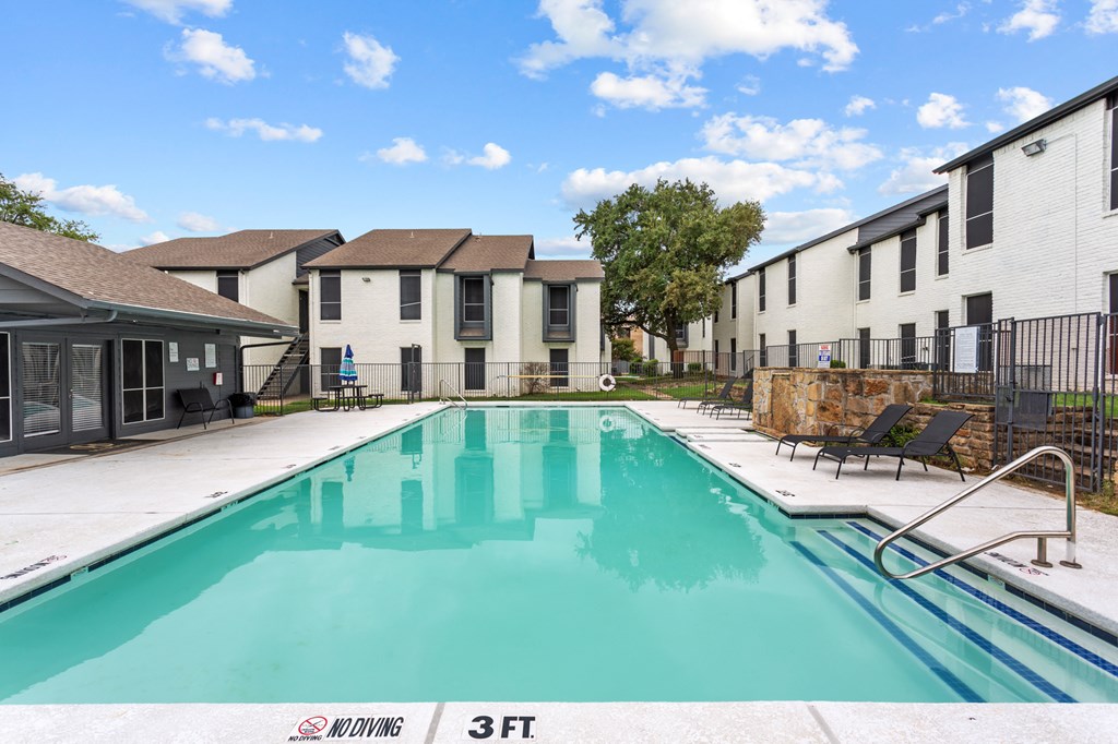 A swimming pool in a residential area with a 3ft depth sign.