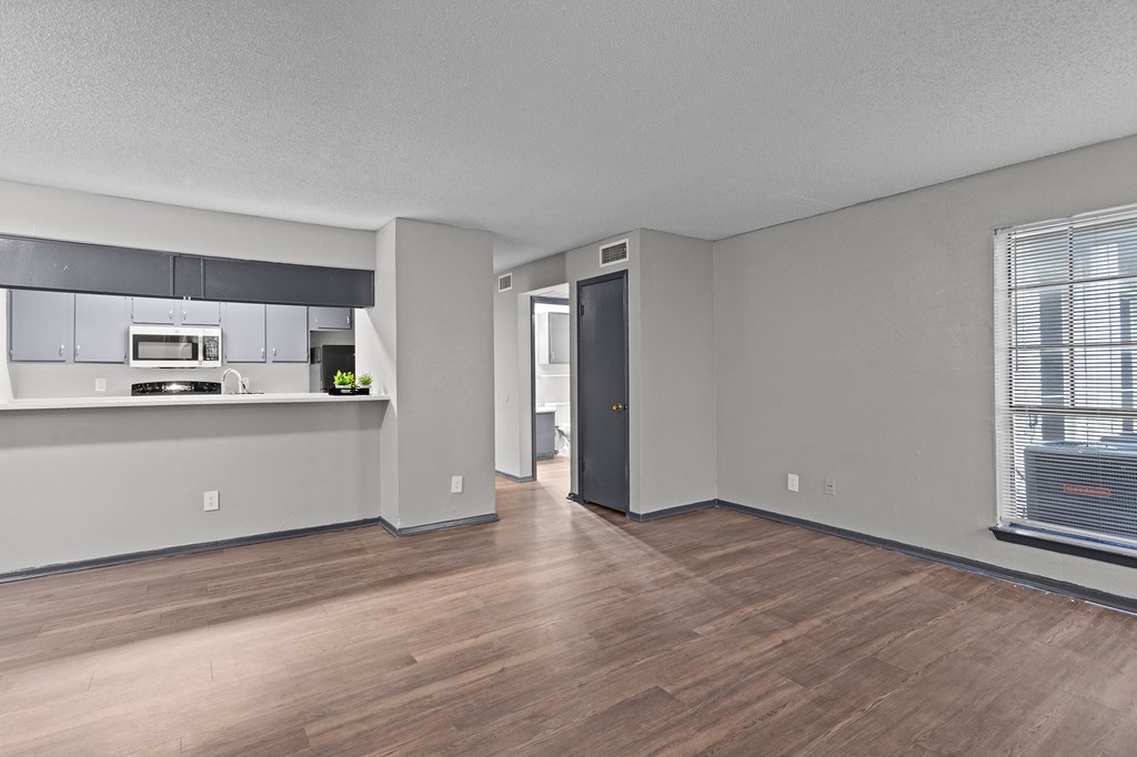 A kitchen area with a microwave, oven, and refrigerator.