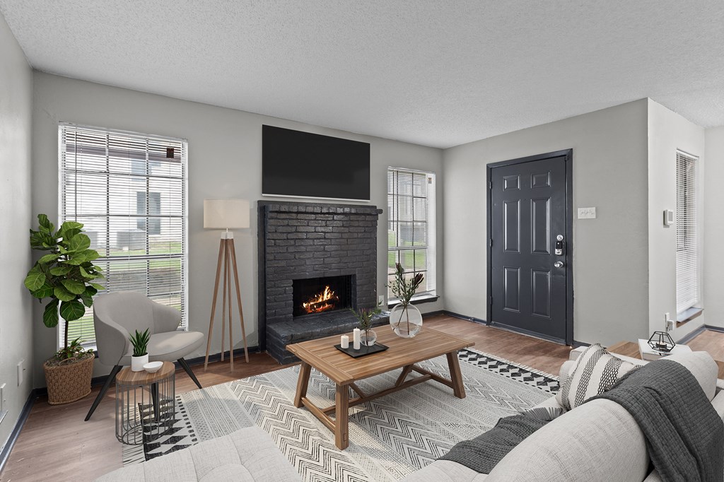 A modern living room with a fireplace and a flat screen TV mounted above it.