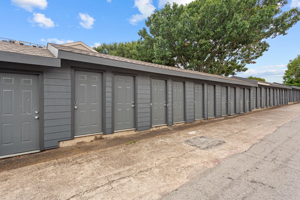 A row of grey garage doors are closed.