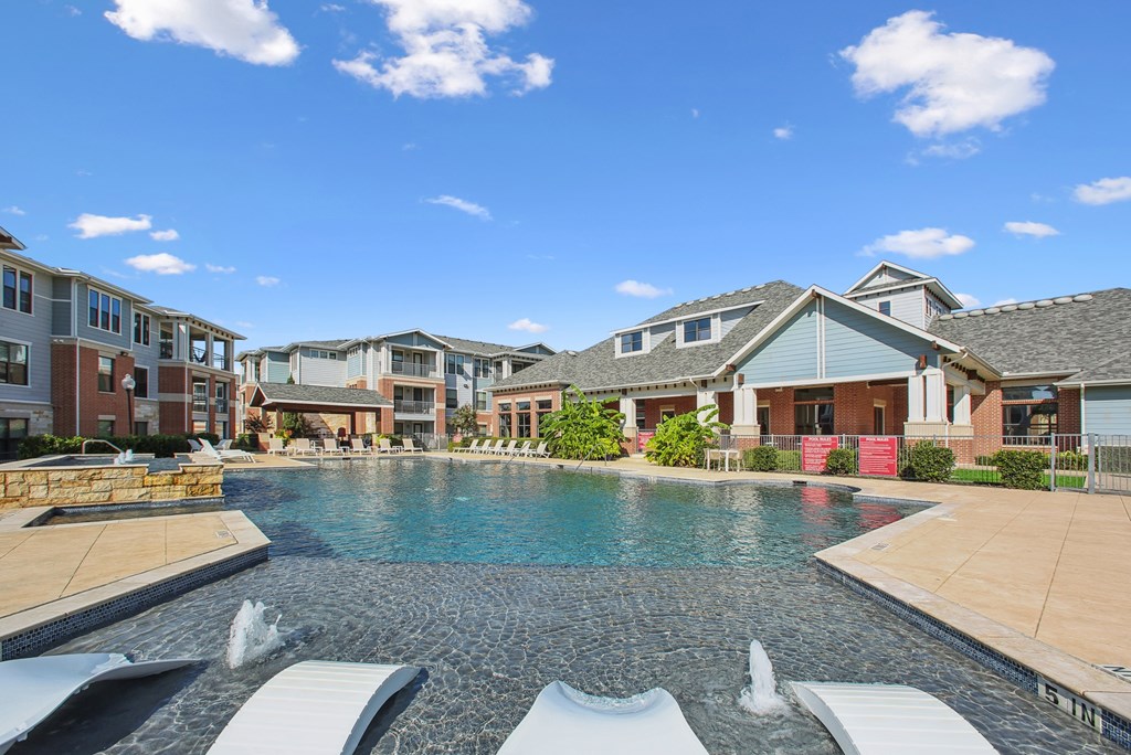 A swimming pool with a waterfall in the middle of it.