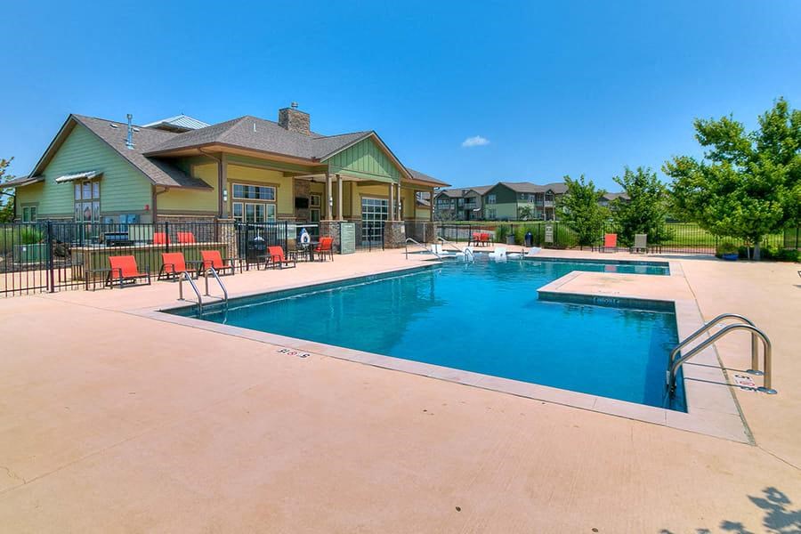 a swimming pool with a house in the background
