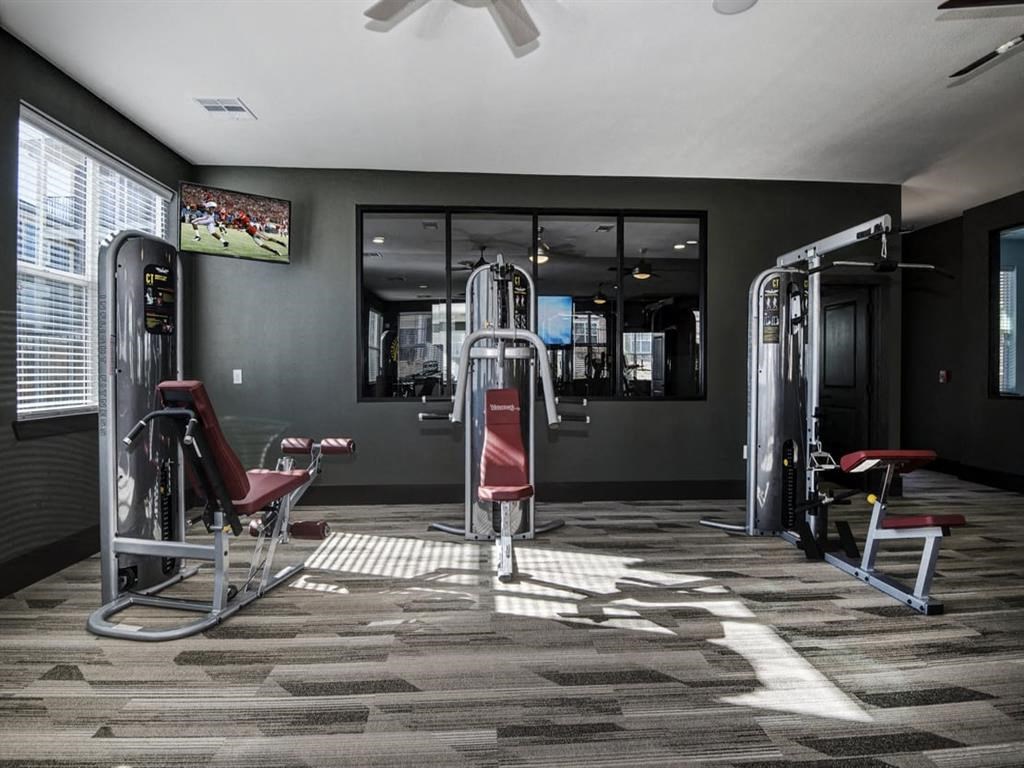 a gym with a lot of chairs and a mirror