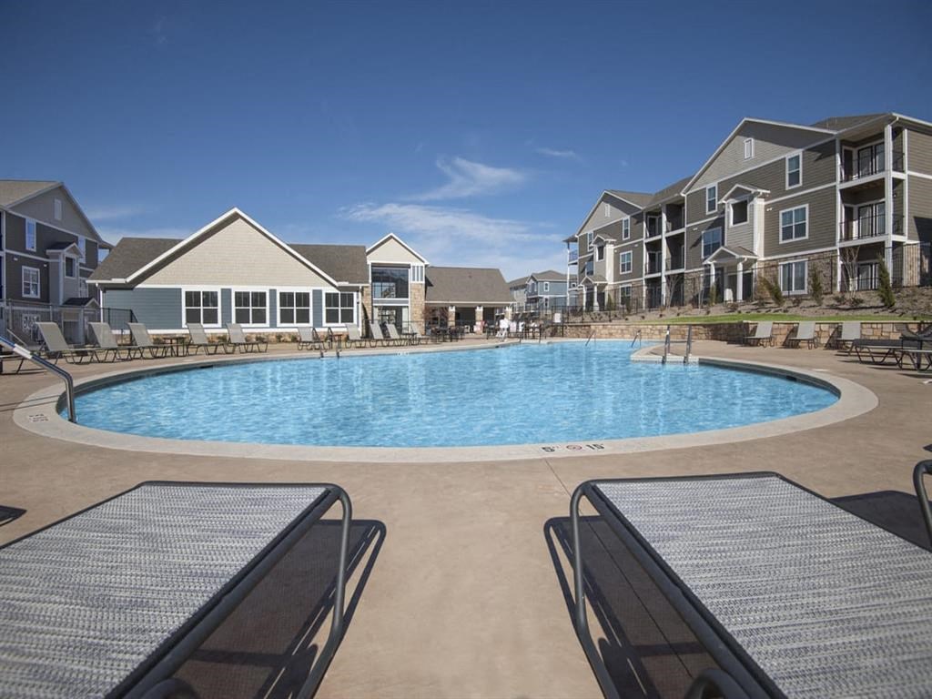 a swimming pool in front of an apartment building