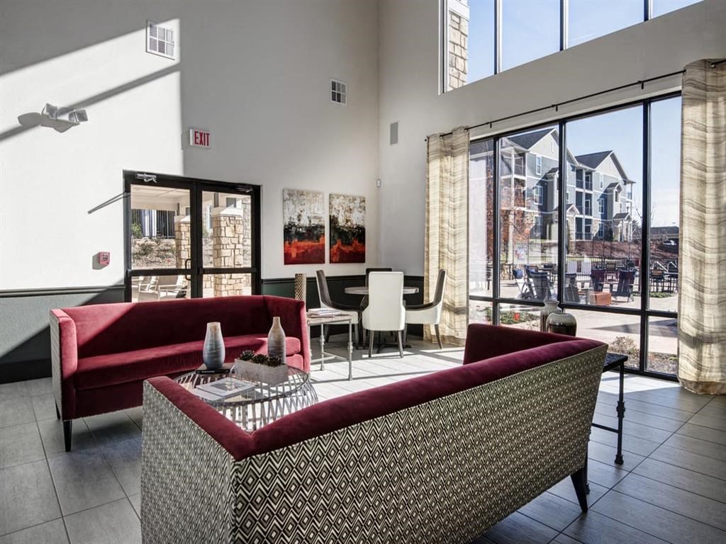a living room with couches and a table with chairs