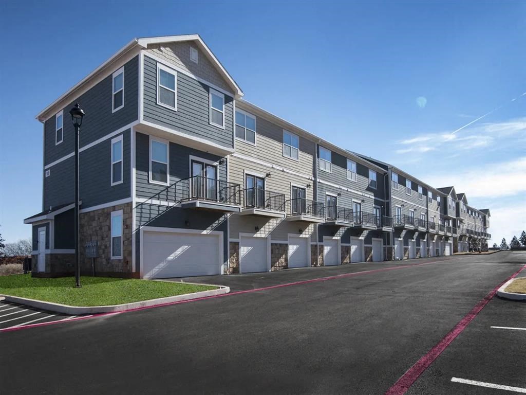 a row of apartment buildings with balconies on a street