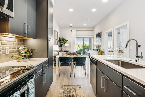A modern kitchen with a dining table set for four.