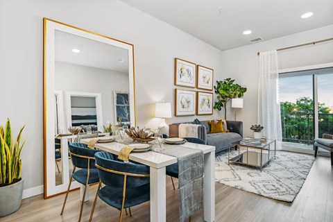 A dining room with a white table and blue chairs.