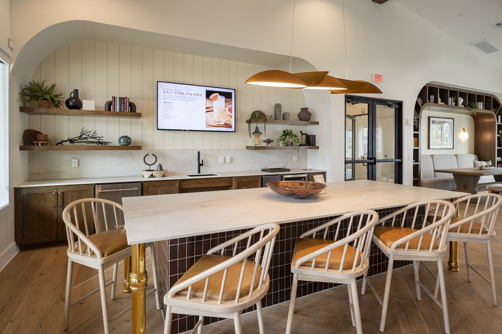 A kitchen with a white table and chairs.