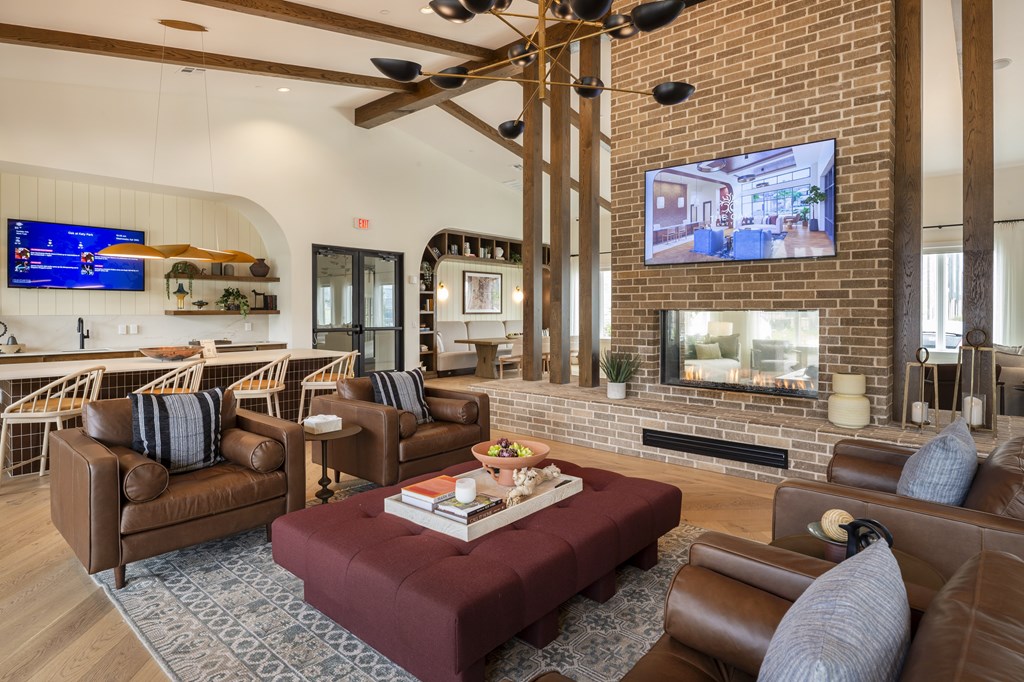 A living room with a fireplace and a television mounted on the wall.