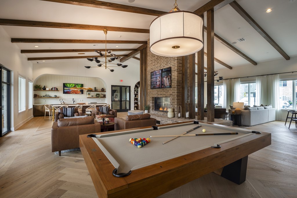 A pool table is in the middle of a room with a billiard ball on it.