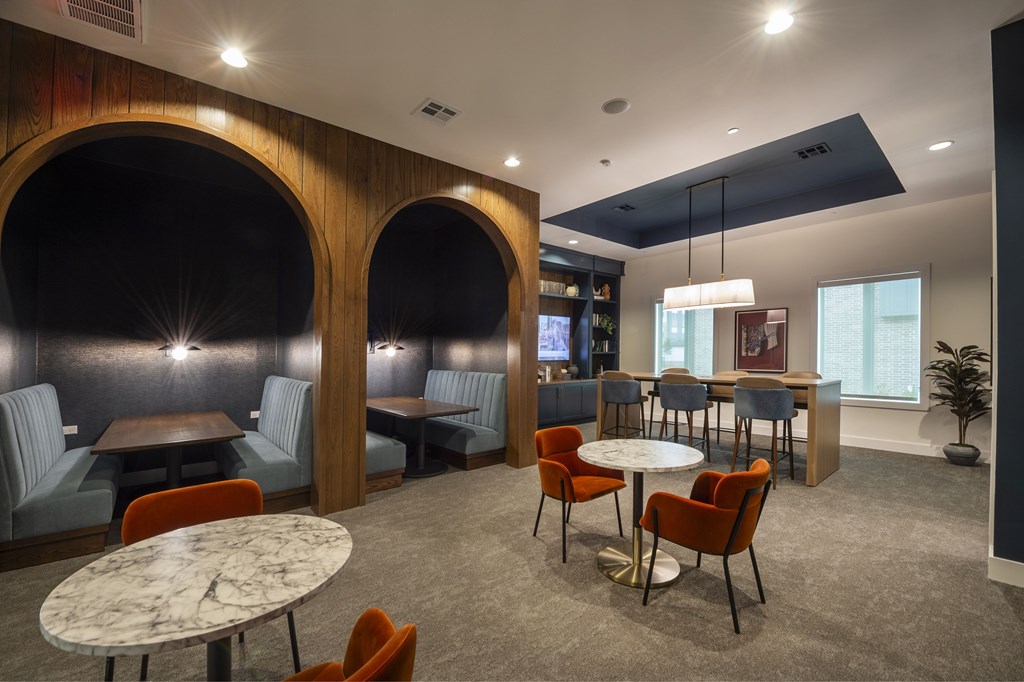 A modern dining area with a round table and chairs.