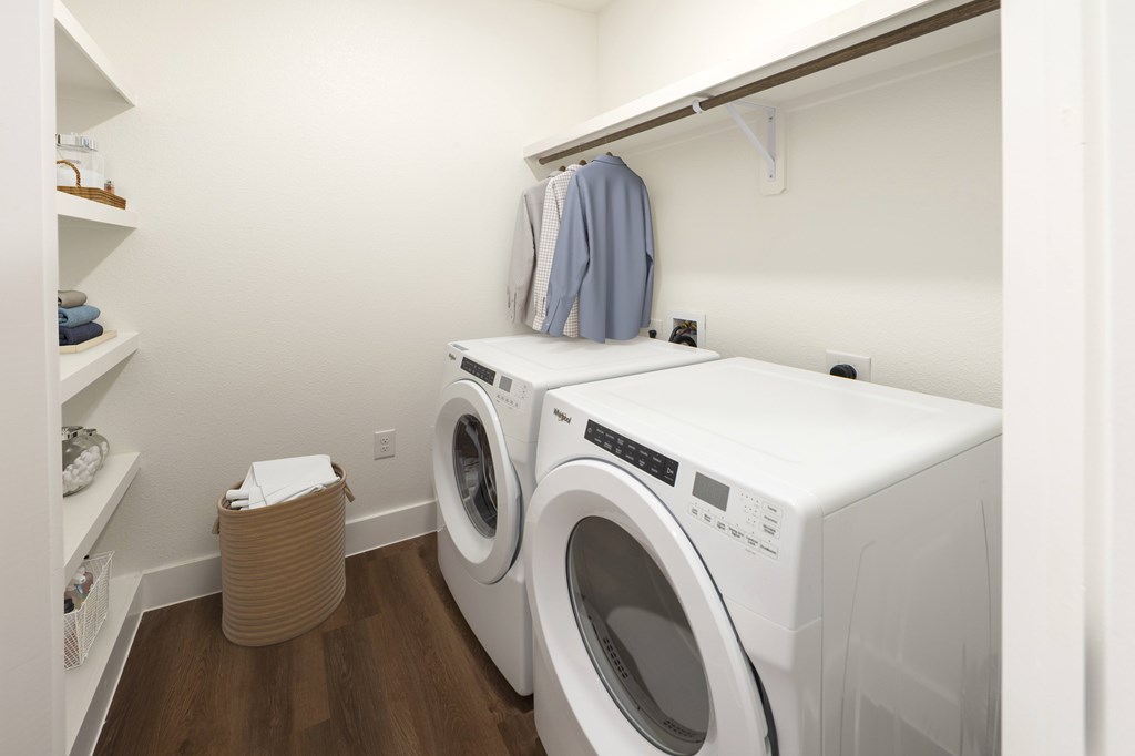 A small laundry room with a washer and dryer.