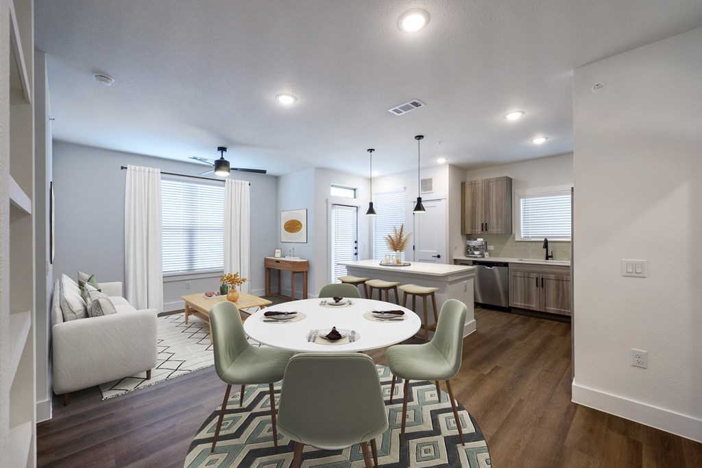 A modern dining room with a white table and chairs.