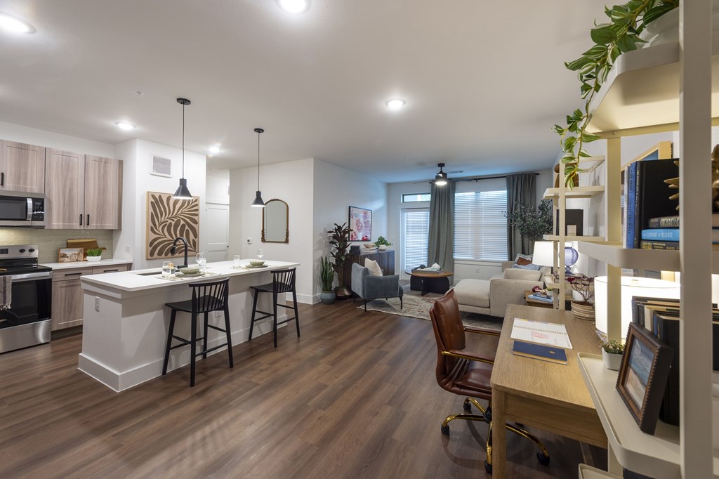 A modern kitchen with a dining table and chairs.