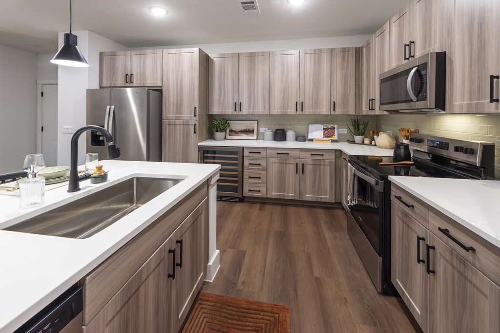 A modern kitchen with wooden cabinets and stainless steel appliances.