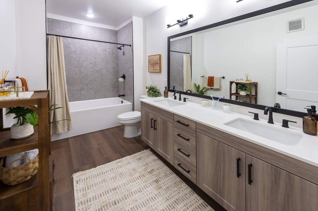A bathroom with a white sink and a white toilet.
