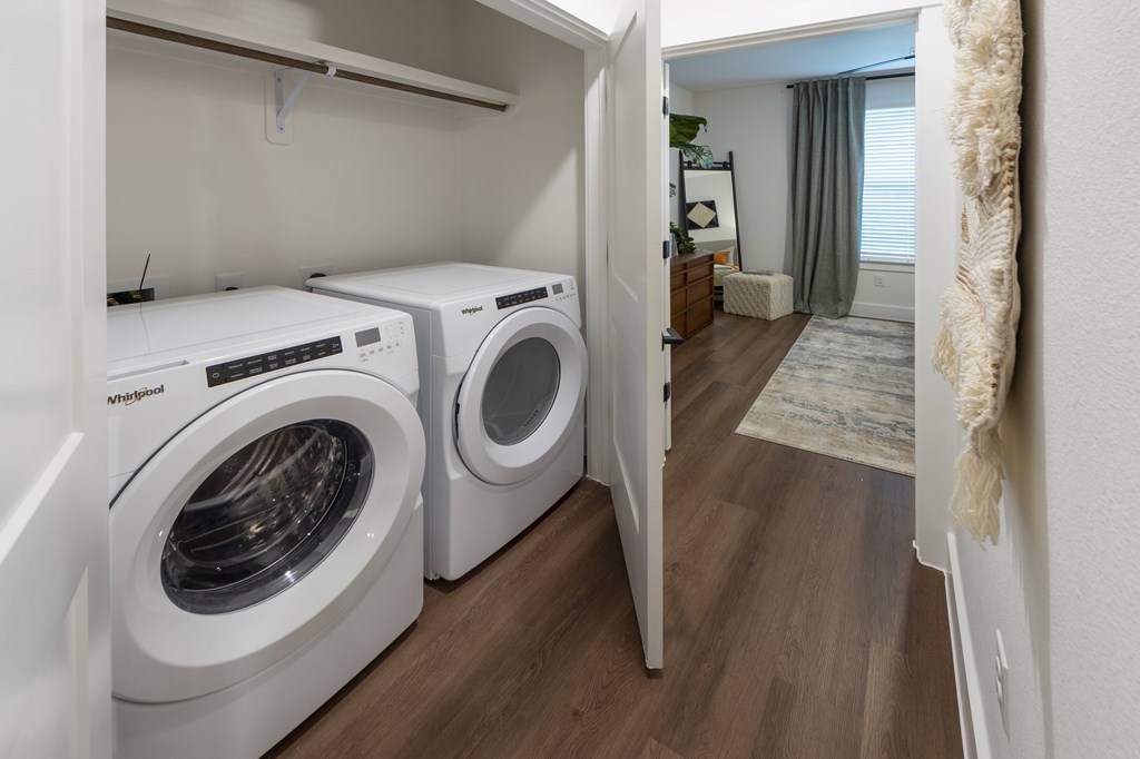 Two front loading washing machines in a laundry room.