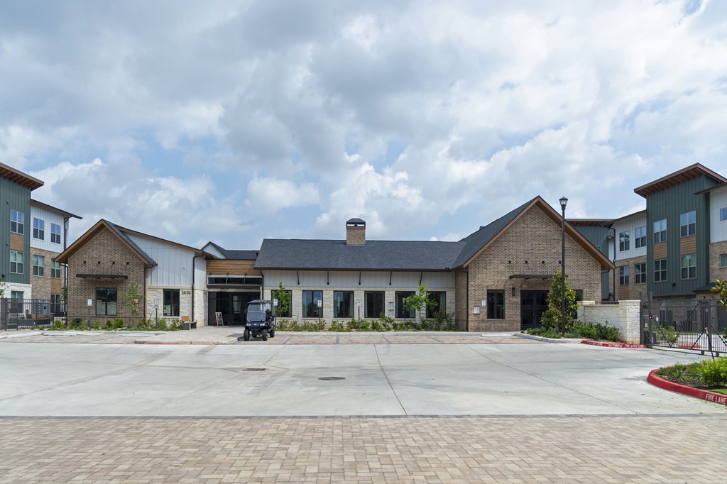 A large building with a parking lot in front.
