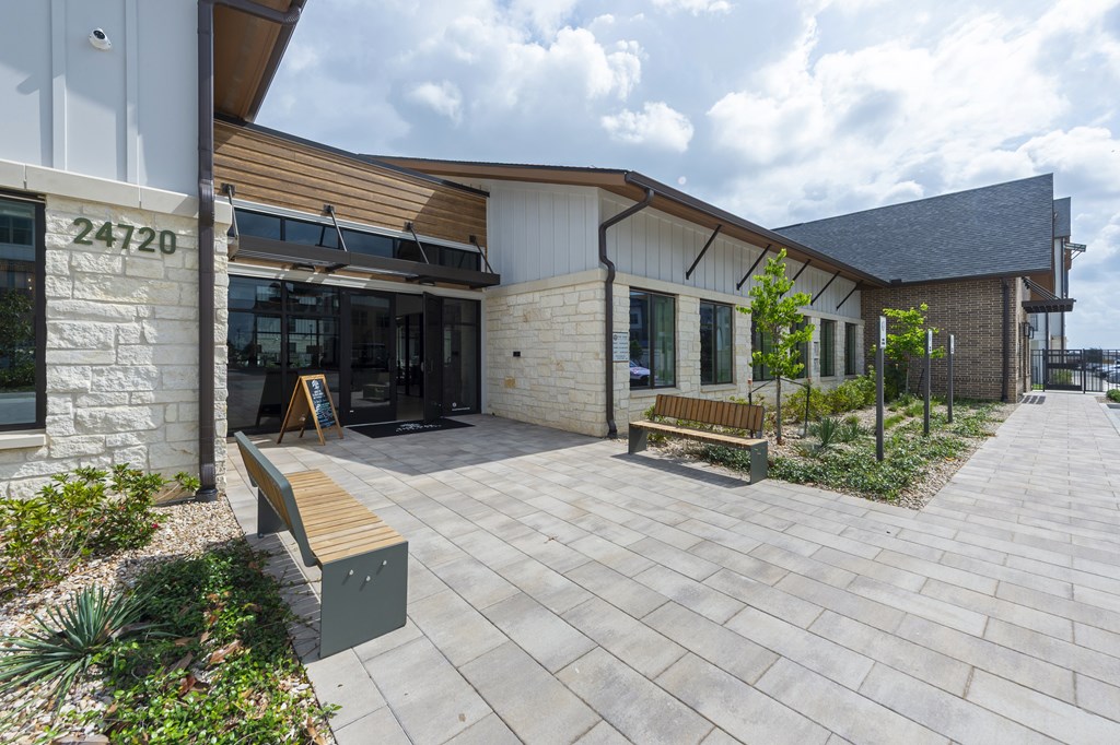A modern building with a stone pillar and the number 24720 on it.