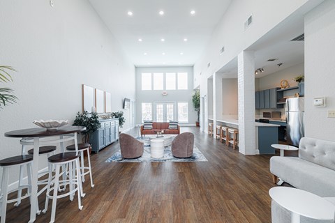 A modern living room with a white couch and a wooden floor.
