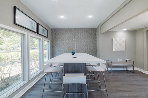 A dining room with a white table and chairs.