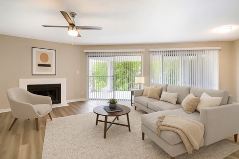 A living room with a fireplace, a chair, a couch, and a coffee table.