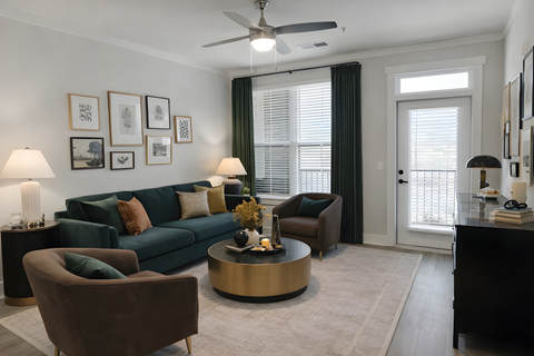 A living room with a green couch, a brown armchair, and a coffee table.