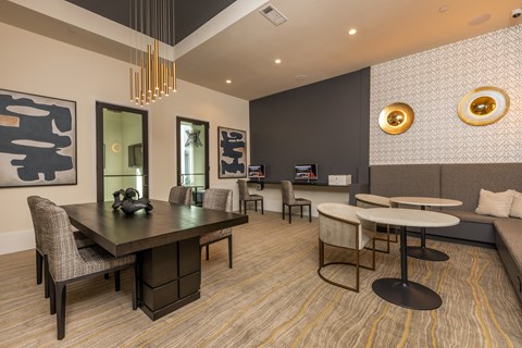 A modern dining room with a dark wood table and chairs.