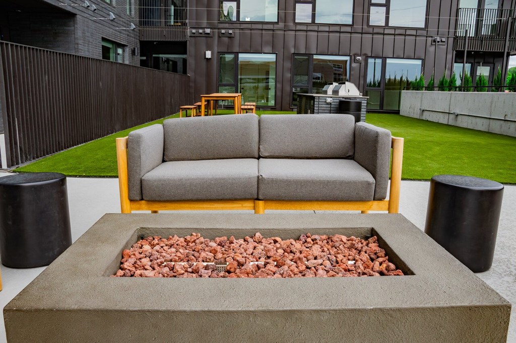 a living room with a couch and a fire pit