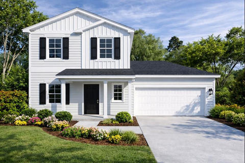 A white house with a black roof and a black garage door.