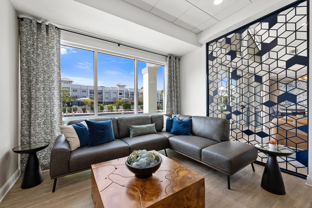 a club house lounge area with a couch and a table