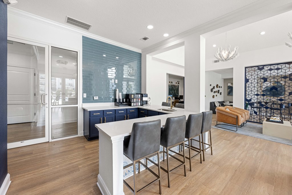 a communal kitchen with a white counter top and blue cabinets