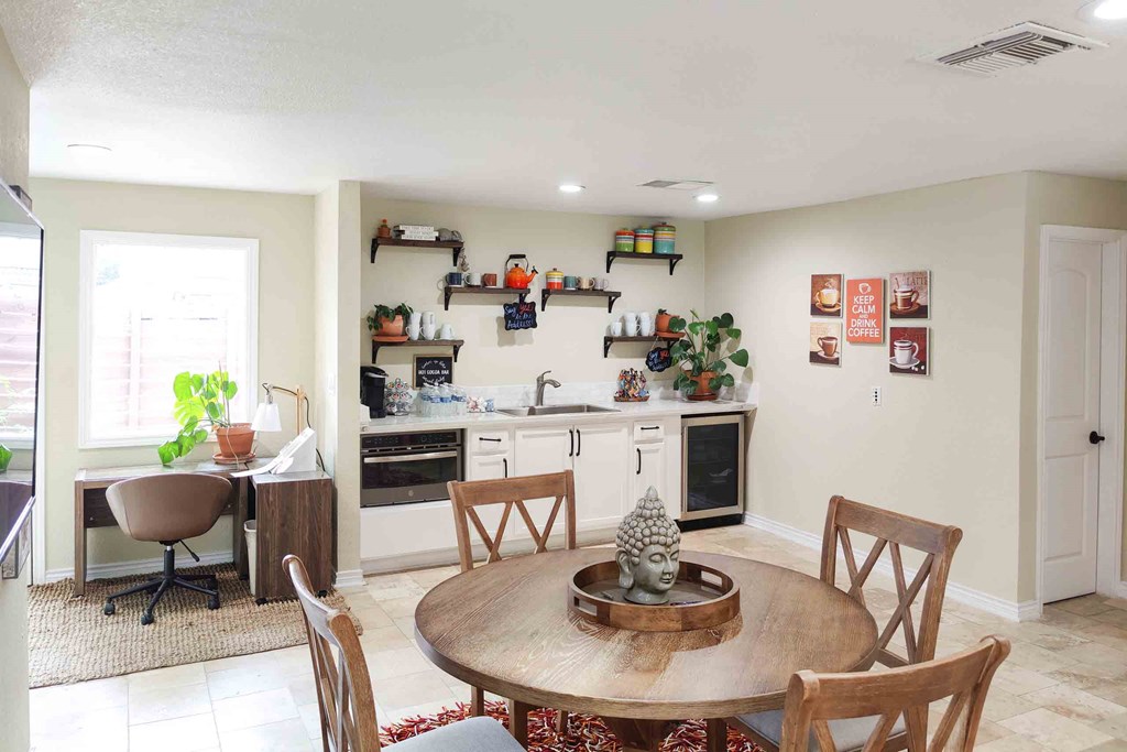 a kitchen and dining room with a table and chairs