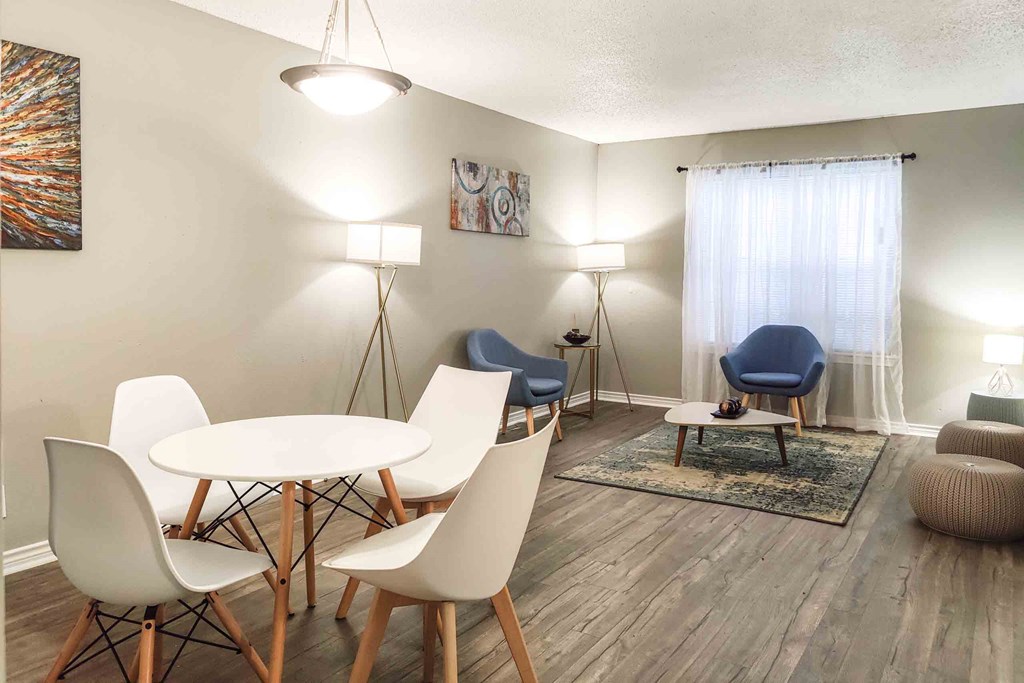 a living room with a table and chairs