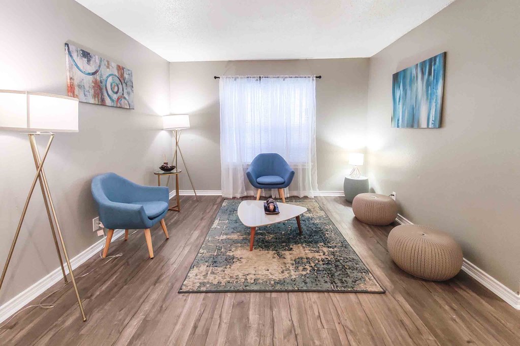 a living room with two chairs and a coffee table