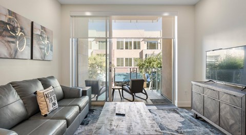 A living room with a grey couch and a chair.