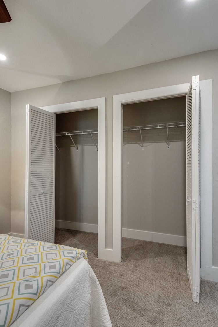 a bedroom with two closets and a bed
