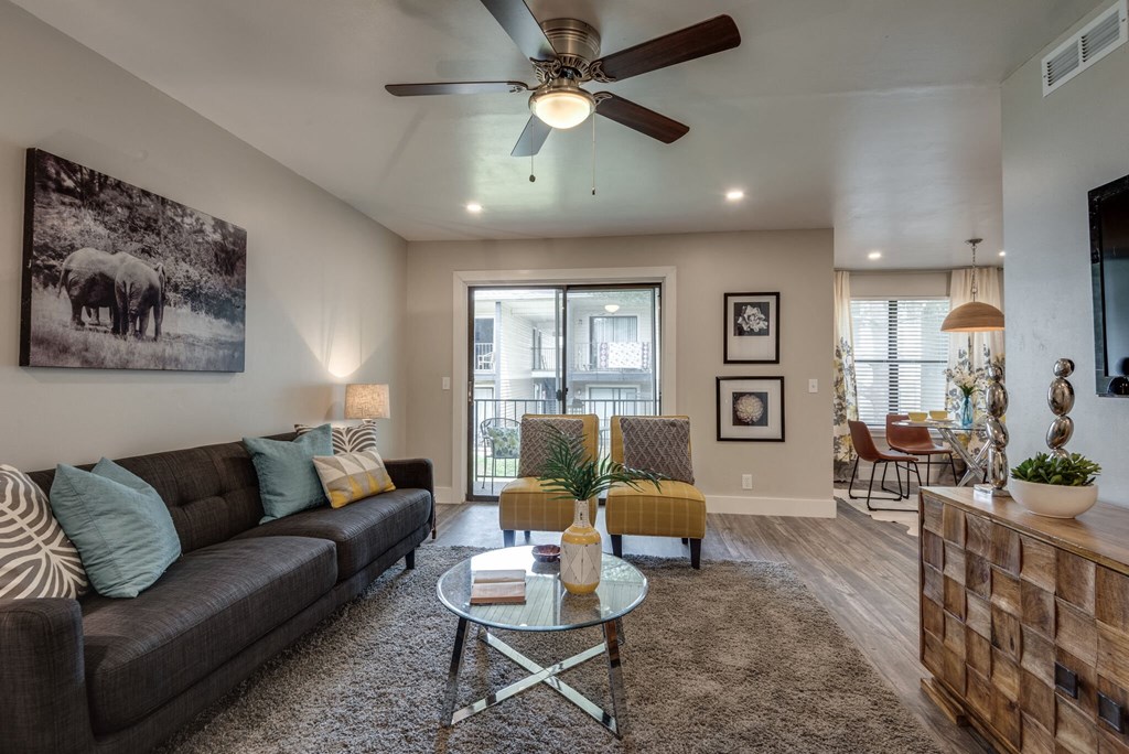 a living room with a couch and a ceiling fan