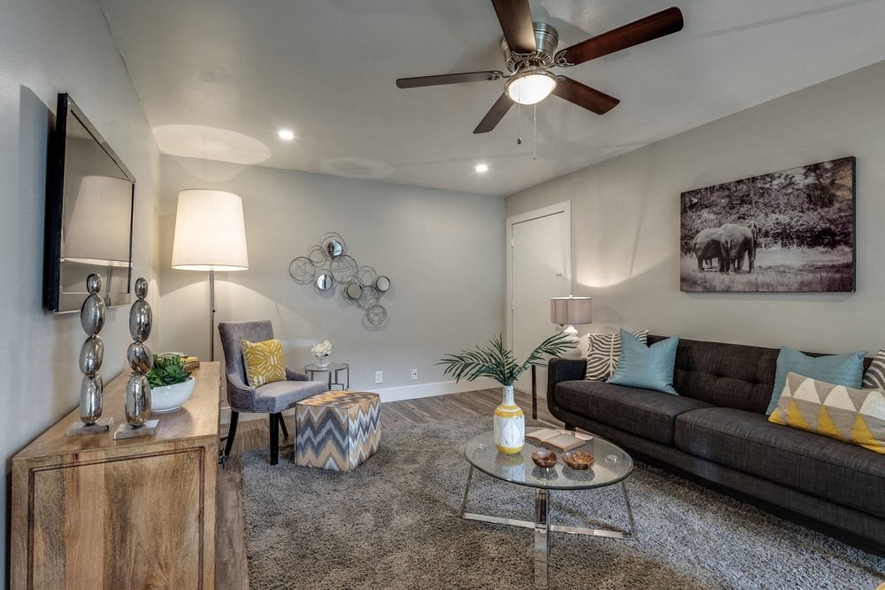 a living room with a couch and a ceiling fan