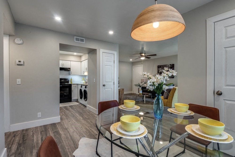 a dining room with a glass table and chairs
