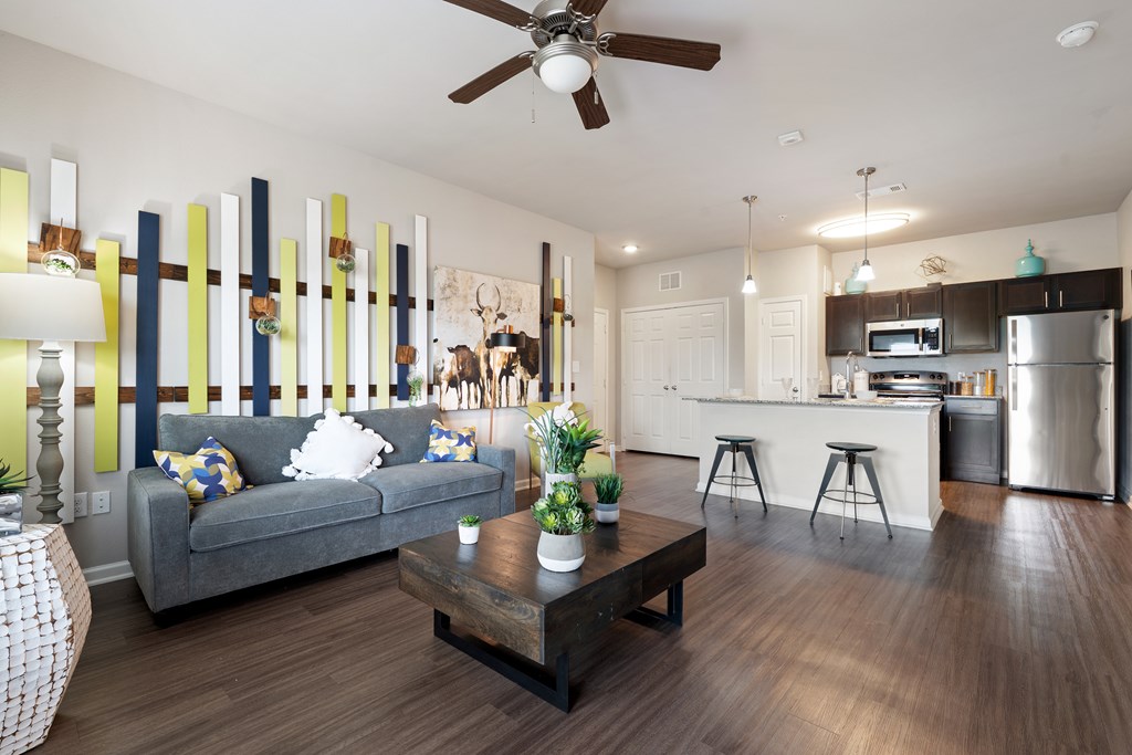 A modern living room with a grey couch and a wooden coffee table.