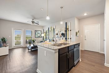A modern kitchen with a large island and a dining table.